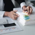Businessman Looking Through Stacks Of Papers On De RRG587R 1 150x150