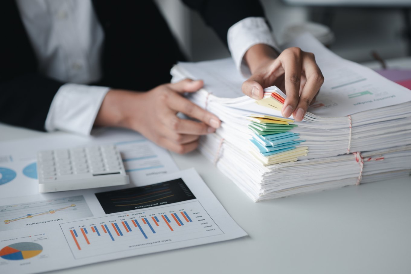 Businessman Looking Through Stacks Of Papers On De RRG587R 1